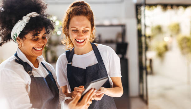 istock Female restaurant employees using a mobile app on a tablet for restaurant management 1600885860
