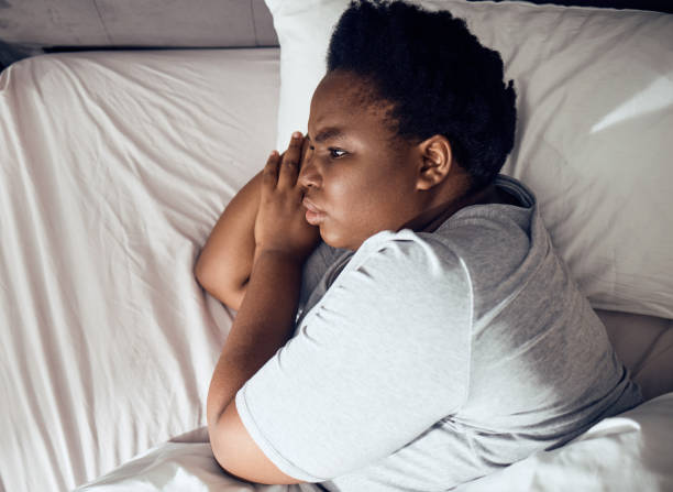 istock Stress, thinking or black woman in bed with insomnia or anxiety from sleeping problem in bedroom. Wake up, burnout or tired African girl with mistake, loss or depression from emotional grief at home 1600886418