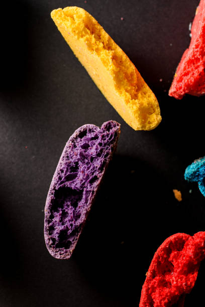 istock Multi colored crushed halves of macaroons on dark concrete background. Top view 1600888103
