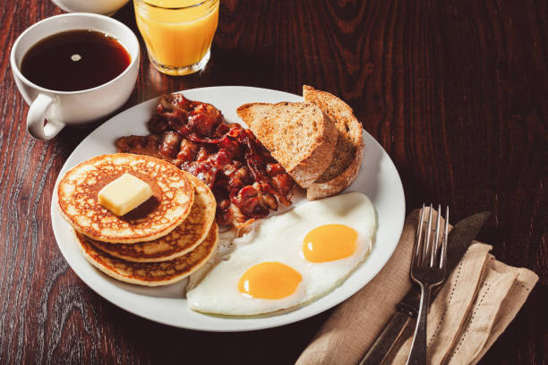 istock traditional full american breakfast eggs pancakes with bacon and toast 1600894304