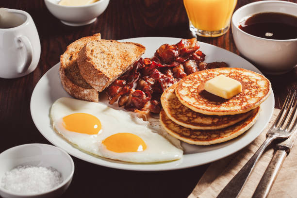 istock traditional full american breakfast eggs pancakes with bacon and toast 1600894817