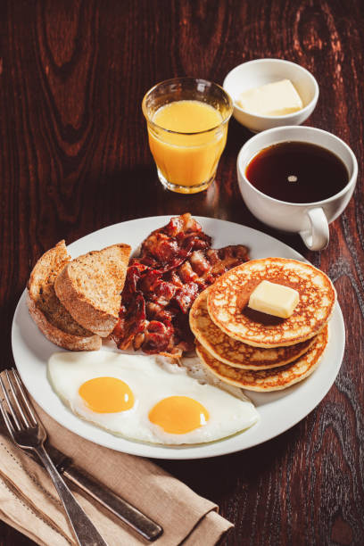 istock traditional full american breakfast eggs pancakes with bacon and toast 1600894836