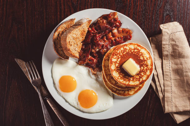 istock traditional full american breakfast eggs pancakes with bacon and toast 1600895355