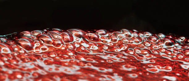 istock Close-up of intricate bubbles in a boiling red liquid 1600895385