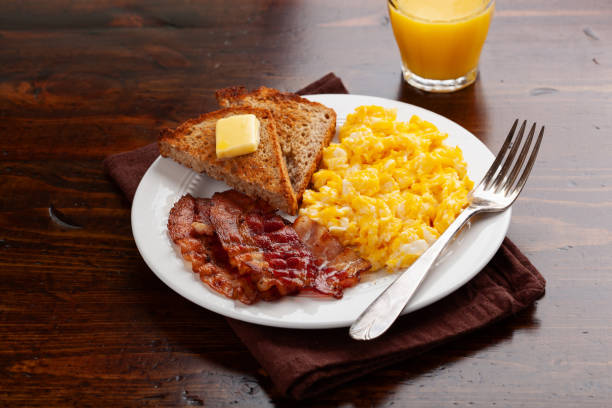 istock traditional scrambled egg breakfast with bacon and toast 1600895888