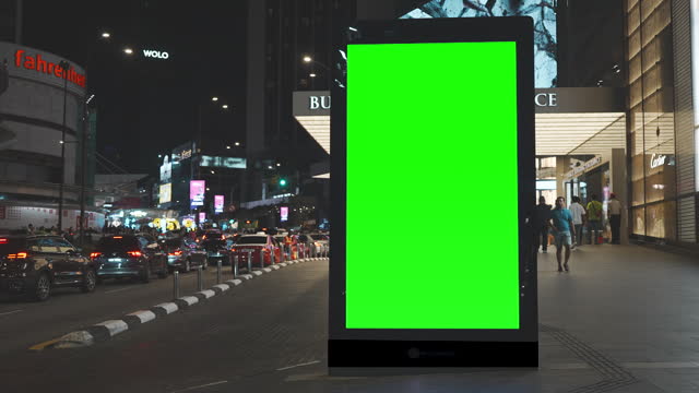 Green mock up blank vertical billboard on the city street for advertisement in Kuala Lumpur, Malaysia