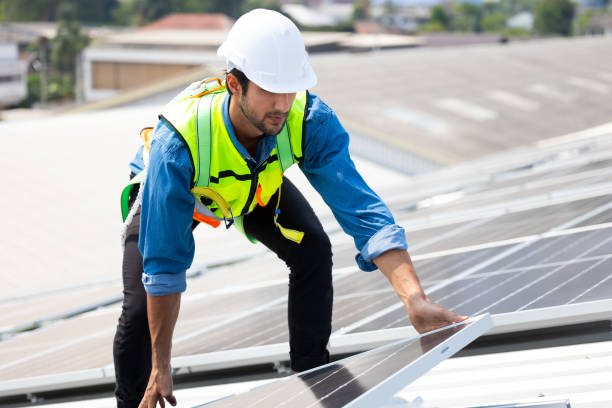 istock electrical engineering man Installing Solar Cell panels on Roof. Solar energy clean and green alternative energy concept. 1600901318