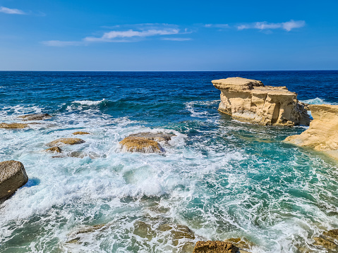 Rocky beach and sea waves in Malta.