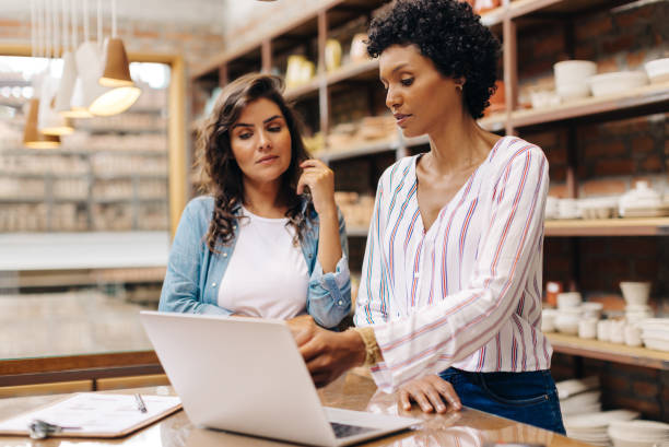 istock Creative businesswomen using a laptop together in their ceramic store 1600905541