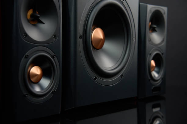 istock Sound audio system with two satellites and subwoofer on dark background. 1600912963