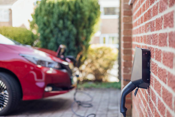 Sustainable transportation with the captivating sight of a vibrant red electric car gracefully charging outside a modern home.
