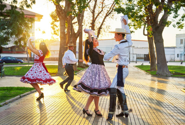 young couples dressed as huasos dance cueca celebrating the national holidays in the city square stock photo