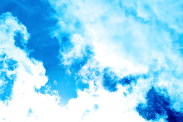 Background with clear contrast between bright blue summer sky and white clouds.