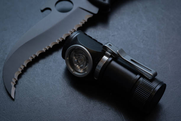 istock Pocket flashlight and knife on the table, close up photo 1600923040