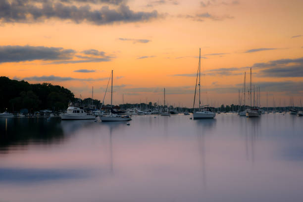 istock Sunset at harbor with sailboat 1600924693