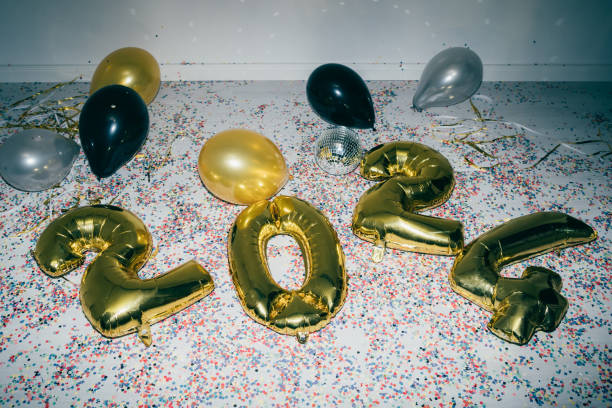 Balloons for New Year 2024 balloons lying on the floor with more colored balloons and confetti scattered around after party stock pictures, royalty-free photos & images