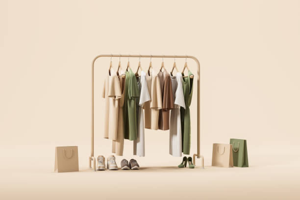 Clothes hanging on a rail, shoes and package on beige background