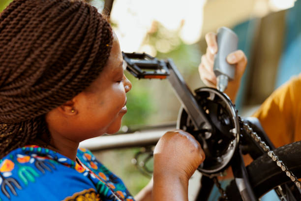 istock Couple maintaining bicycle parts in yard 1600934954