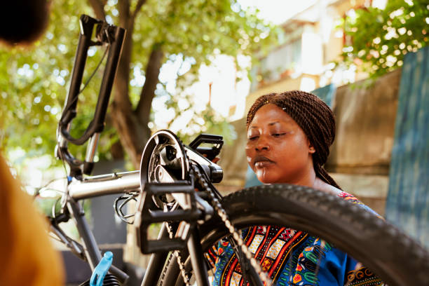 istock Active female cyclist fixing bike chain 1600939018