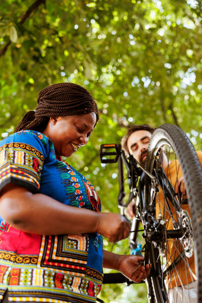 istock African american woman fixing bicycle 1600939634