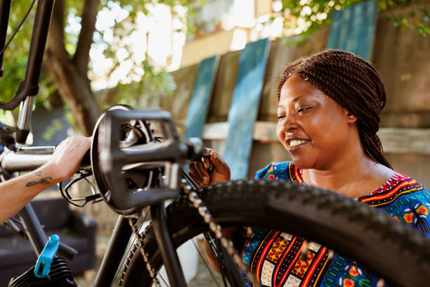 istock Black woman adjusting bicycle parts 1600942559