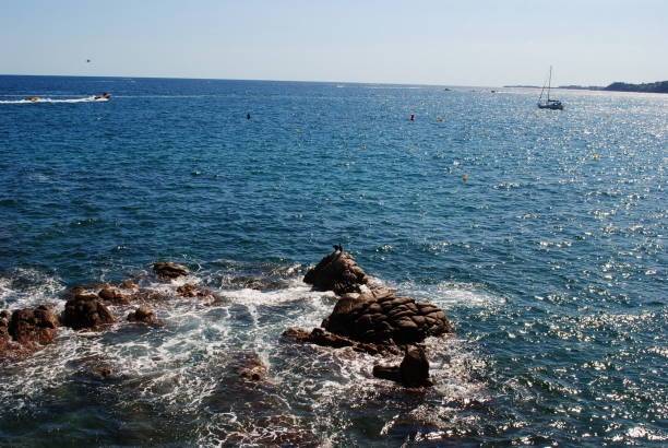 Mediterranean sea. Sunny day. Wet stones and rocks.Spain