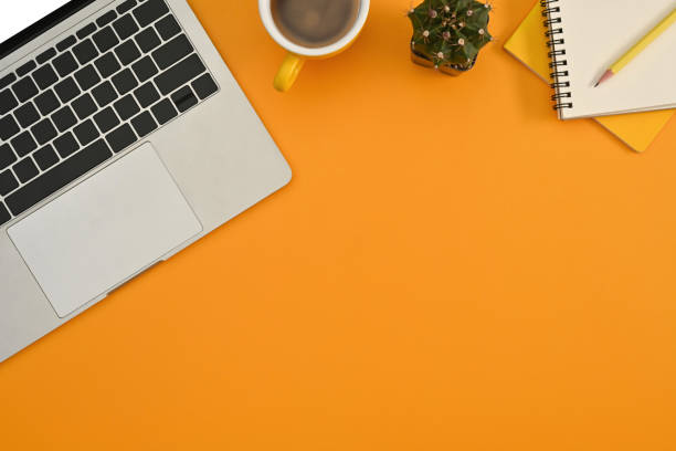 istock Copy space on yellow background, Top view of laptop, coffee cup, paper note. 1600945406