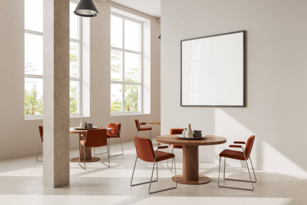istock Round table with chairs in white cafe with poster 1600959651