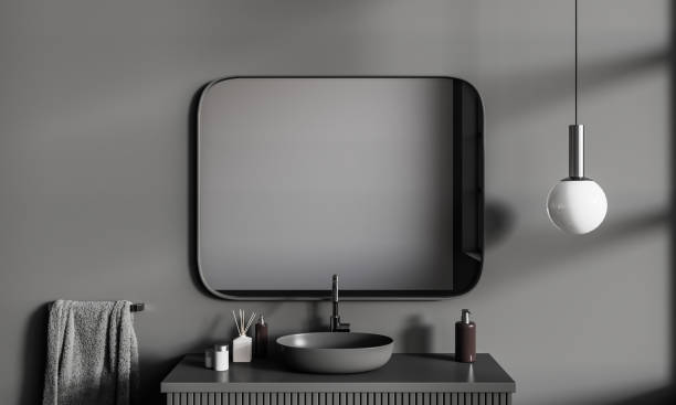 istock Grey modern bathroom interior with sink and mirror, accessories on deck 1600965244