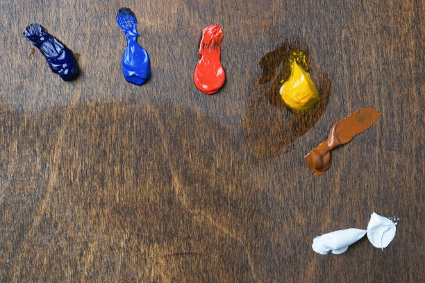 Oil paints squeezed out of tubes on a wooden palette Oil paints squeezed out of tubes onto a new wooden palette. limited palette oil paint palette stock pictures, royalty-free photos & images