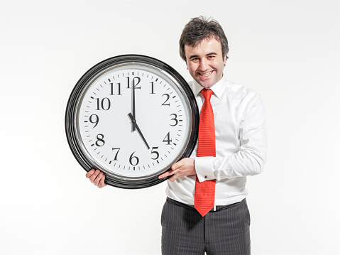 Businessman holding clock.