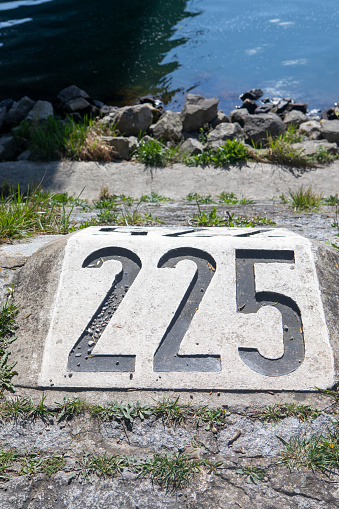 225km marker on the banks of the Rhine River at Breisach, Germany