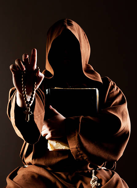 istock Mystery preaching monk with bible 160098425