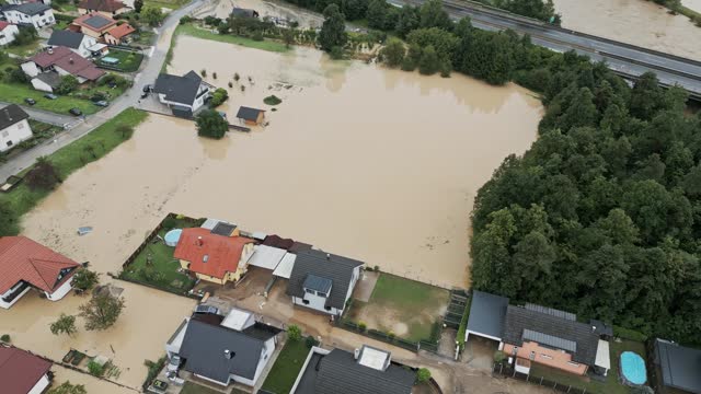 Aerial view of flooded houses and rescue vehicles saving people