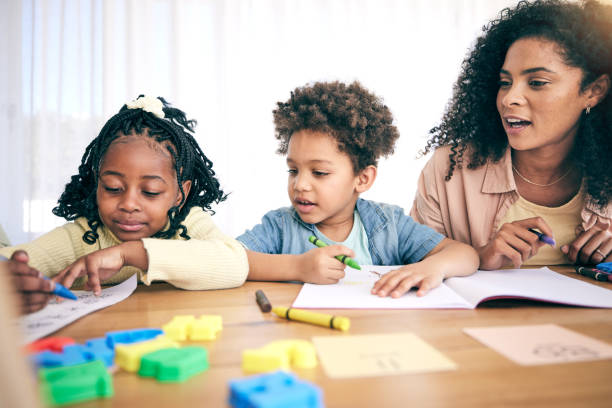 istock Books, drawing and mom with children for homework, school activity and learning with paper. Black family, education and happy mother with boy and girl smile for teaching, lesson and help at home 1600999909