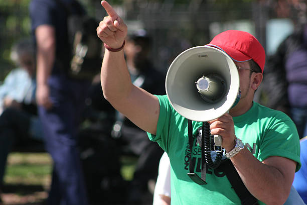 protest Protester pointing finger and holding megaphone political rally photos stock pictures, royalty-free photos & images