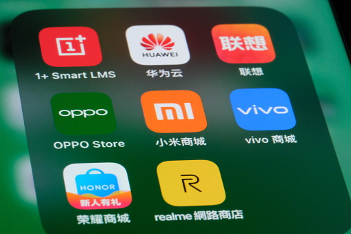 Shanghai,China-August 4th 2023: Xiaomi, Oppo, Vivo, OnePlus, Huawei, Lenovo, Honor, Realme icons on phone screen. Assorted Chinese electronic smartphone company