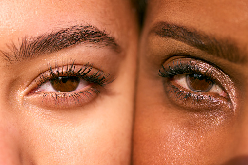 Close Up Portrait Showing Eyes Of Mature Mother With Teenage Daughter Face To Face
