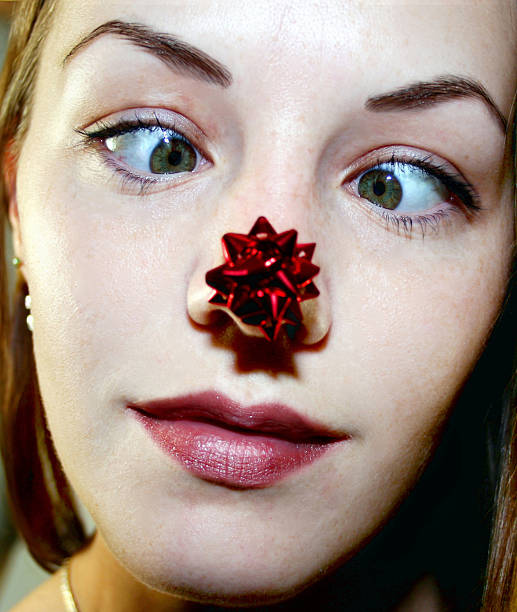 Girl with Christmas bow on nose