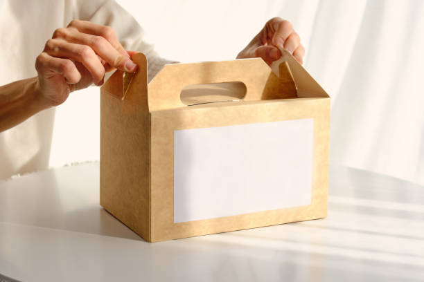 istock Woman packing box with food placed on table 1601032405
