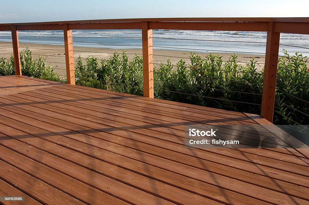 Beach house deck Relaxing view of the beach from a deck. Deck Stock Photo