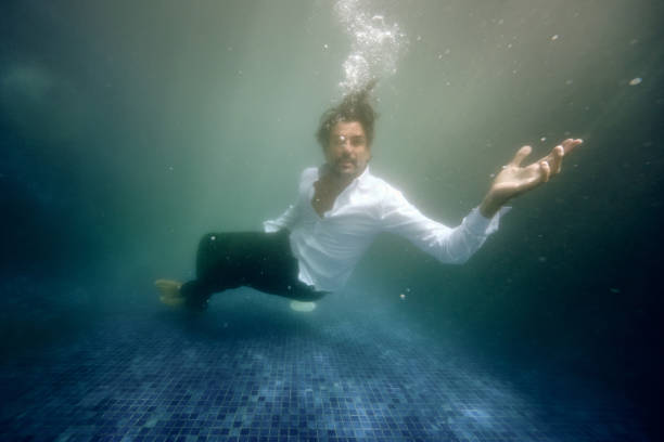 istock Sad man drowning in water in pool 1601042378