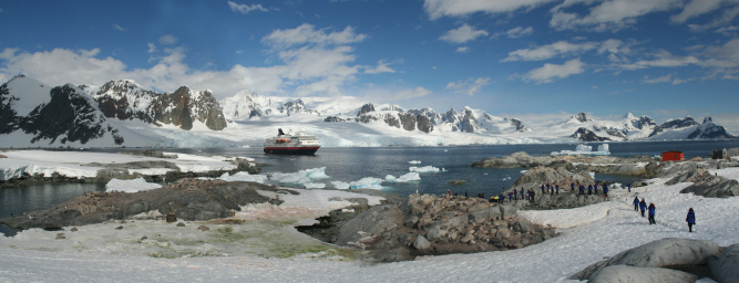 atmospheric landscape in Freud Passage with icebergs and small pieces of ice floating in Antarctica
