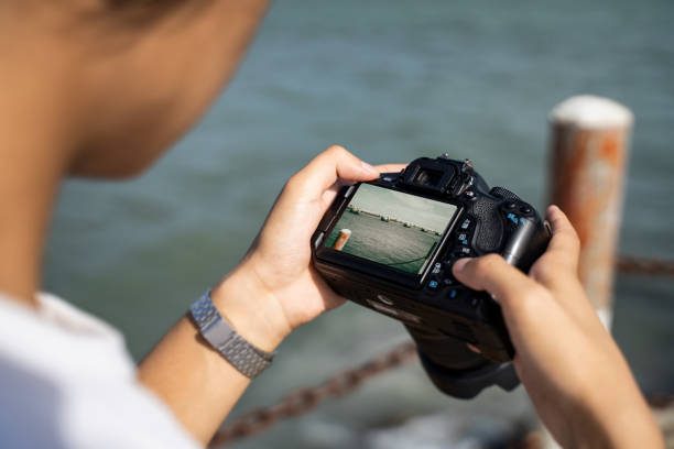 istock A boy taking pictures at the seaside with a camera 1601047142