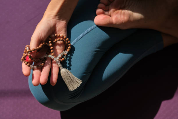 istock Flexible woman with beads doing yoga in Lotus pose 1601048259