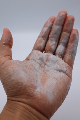 Close-up photo of hands with cleansing foam