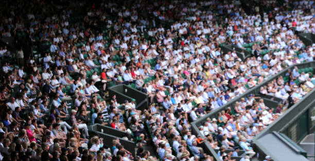 Spectators at Wimbledon Wimbledon, London, UK - July 10, 2017:  Blurred crowd spectators watching the tennis match at Centre Court. wimbledon stock pictures, royalty-free photos & images