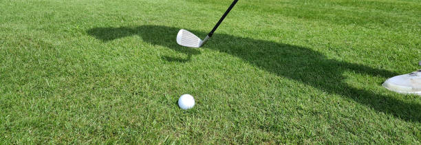 istock Hitting golf ball on field with golf club 1601065630