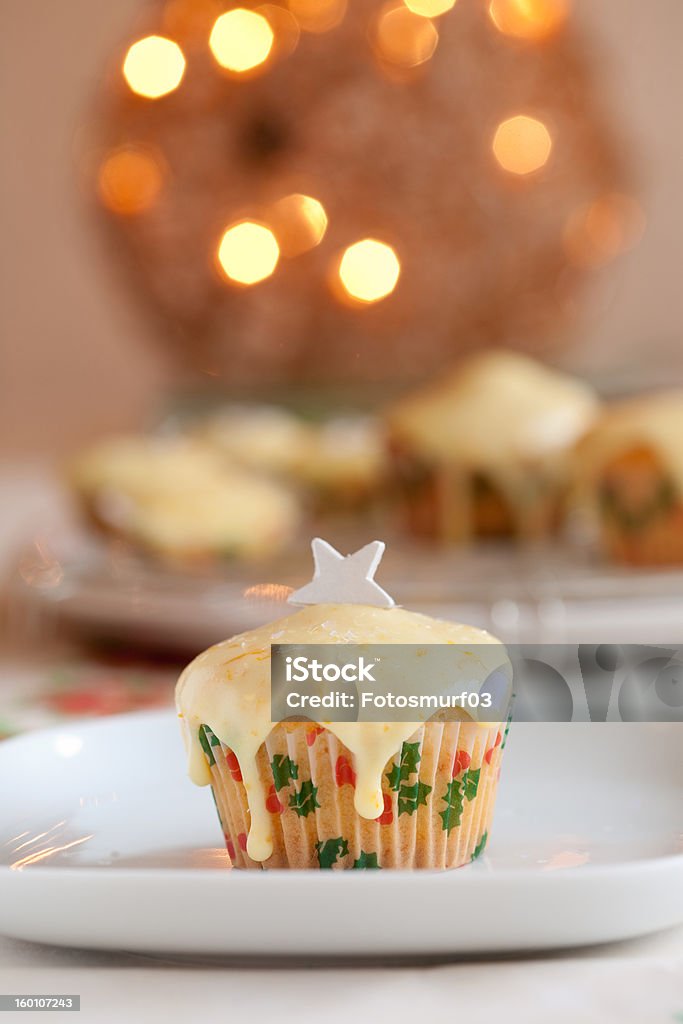 Christmas cake Small christmas cake with christmas lights in the background Cake Stock Photo