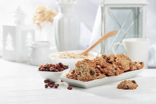 Oatmeal raisin cookies on a white table. Copy space.